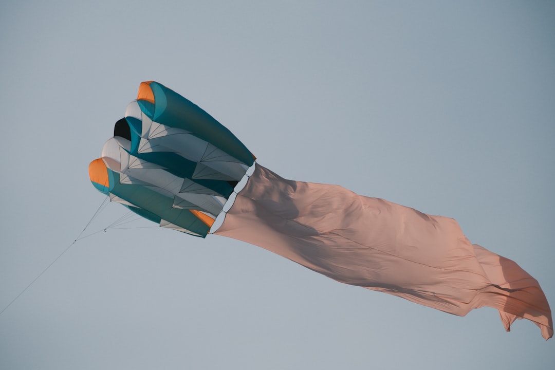 A colorful kite is flying high in the sky.